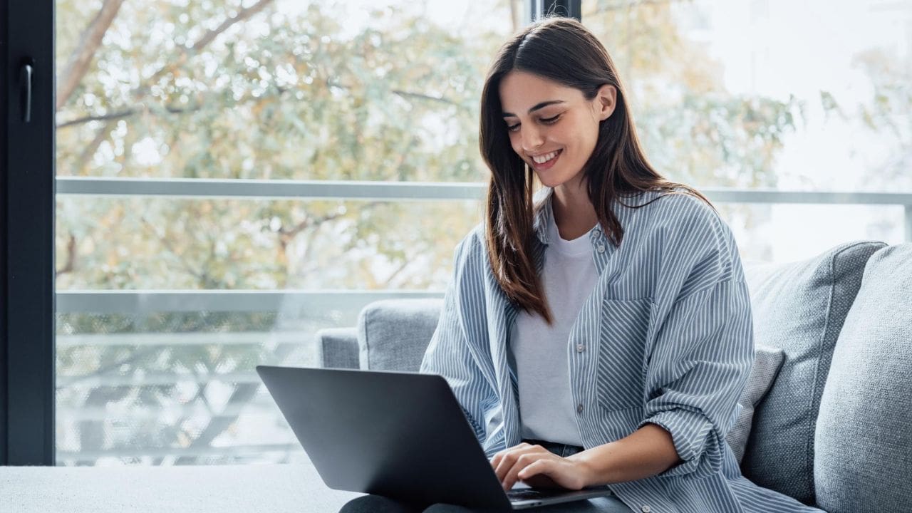 Job seeker reviewing resume on laptop for Applicant Tracking System optimization